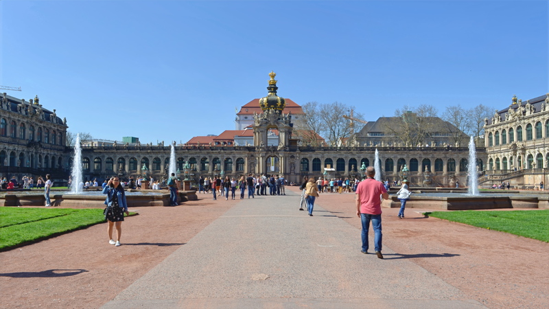 20 - The famous Zwinger Palace in Dresden, Germany, highlighting its grand courtyard, manicured lawns, fountains, and the iconic Crown Gate (Kronentor) in the background